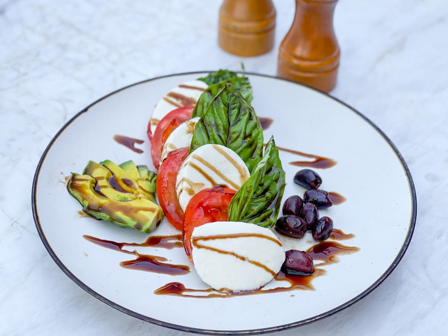 Heirloom caprese with fresh mozzarella, ripe tomatoes and avocado