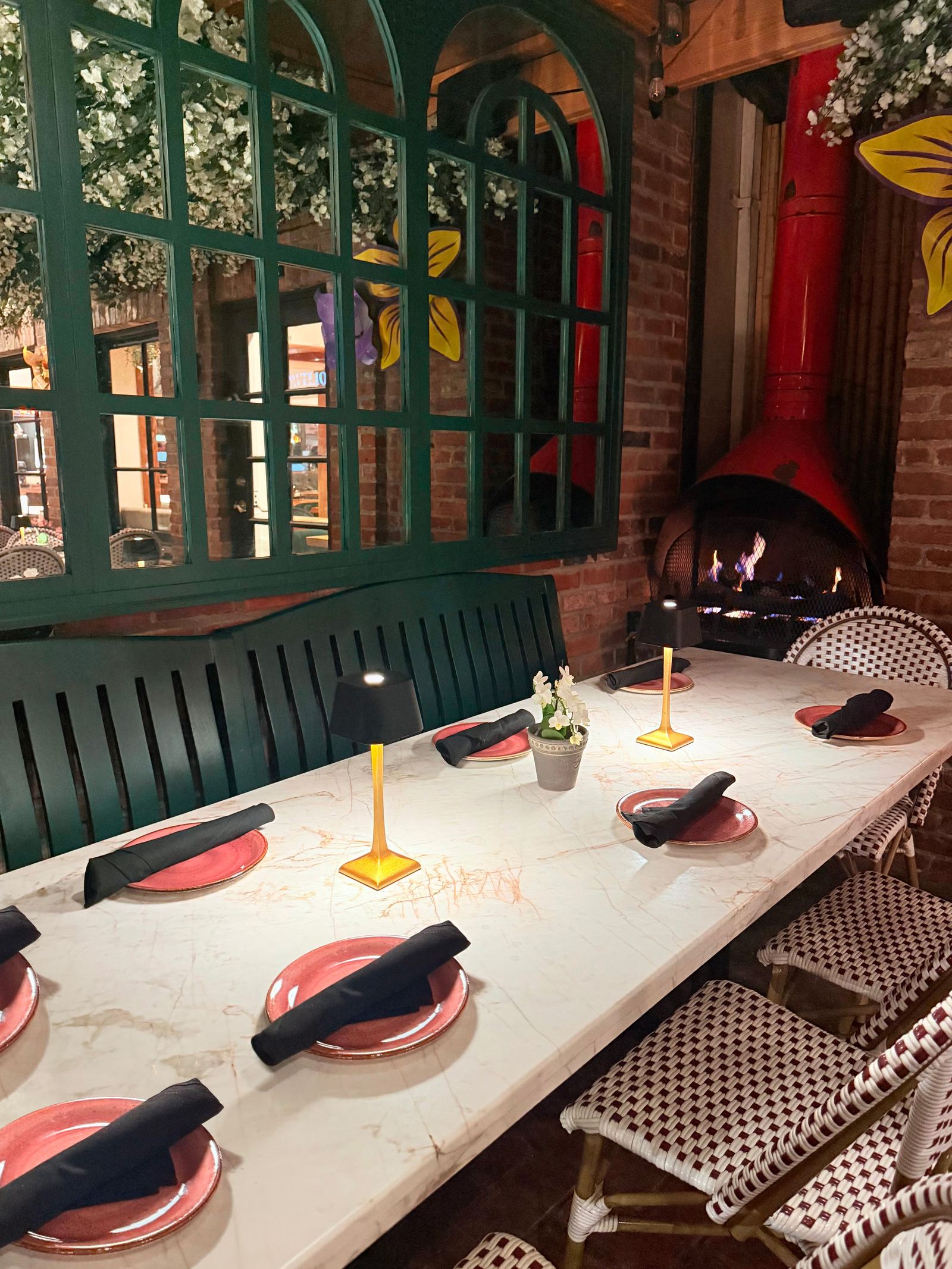A large outdoor table on the patio set for a party